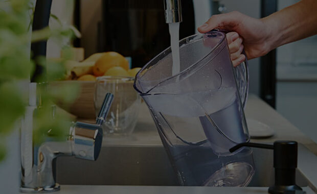 Pitcher Getting Filled Up With Clean Water