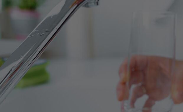 Water About To Be Poured Into A Glass