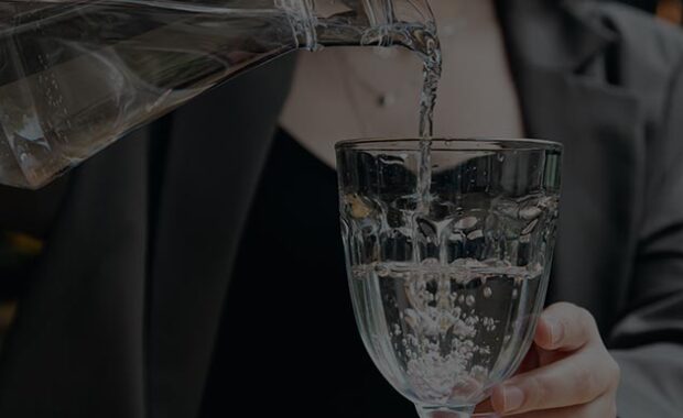 Pouring Water From Pitcher Into Glass