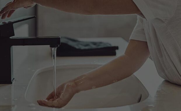 Water From Faucet Into Woman's Hand