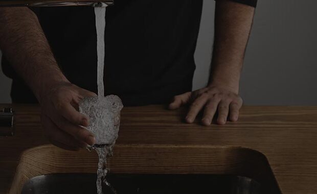 Pouring Water From Faucet Into Glass