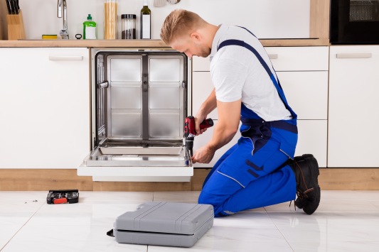 Repairman Repairing Dishwasher