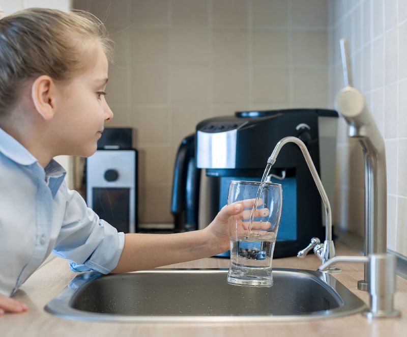 Little Girl Getting Water From An RO Water Filtration System