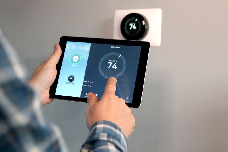 Man Fixing Thermostat