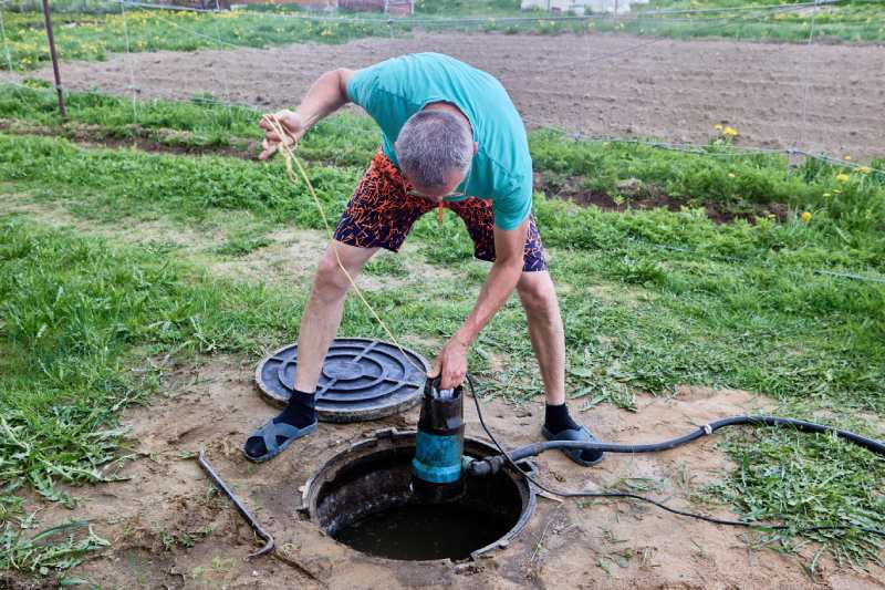 Man Installing A Submersible Well Pump