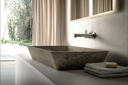 Stone sink modern bathroom minimalist style natural light textured wall neutral color elegant serene clean contemporary design. rectangular stone sink sits smooth countertop with wall mounted