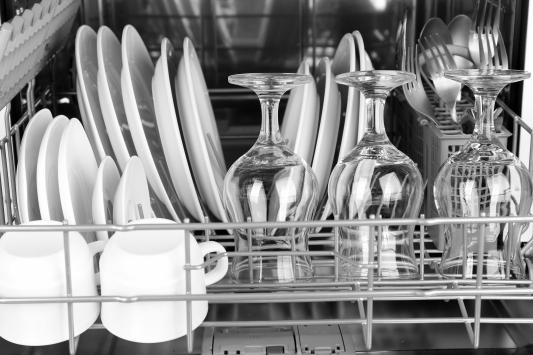Open dishwasher with clean utensils in it