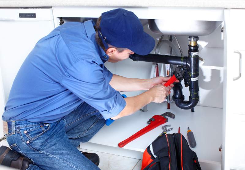 Plumber Performing Kitchen Sink Installation & Repair Services