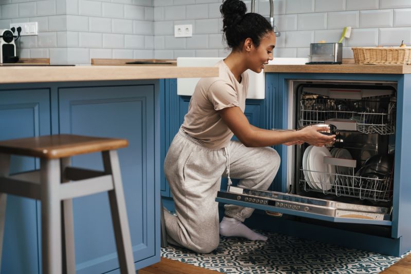 Woman In Front Of Dishwasher