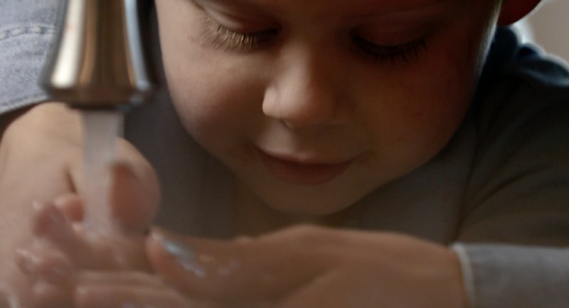 Boy Washing His Hands After Their Residential Septic System Services