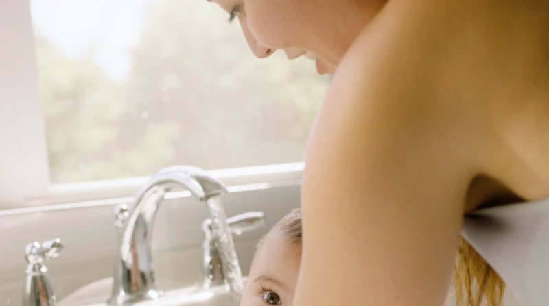 Mother Giving Her Daughter A Bath
