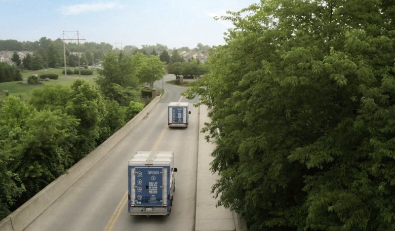 Tri-County Work Trucks Leaving A Commercial Water Treatment System Installation