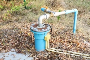 artesian well pumped from a submersible pump powered by photovoltaic power on a dirty concrete background