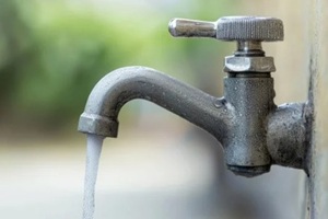 exterior water faucet with flowing water