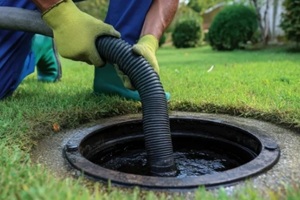 man draining septic tank system