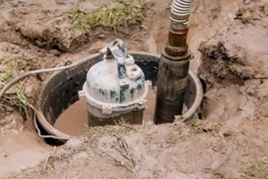 submersible water pump in muddy ground