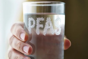 PFAS in drinking water, toxic contamination risk, hand holding glass, invisible chemical danger, health hazard alert