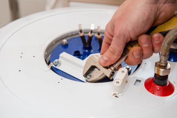 Master hands repair boiler with adjustable wrench