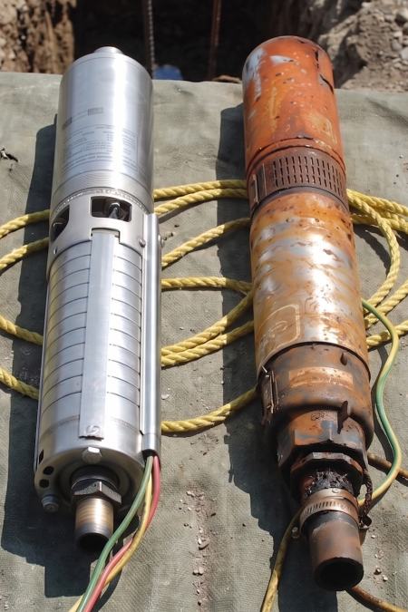 a new submersible well pump model laid against an old rusty one that no longer works