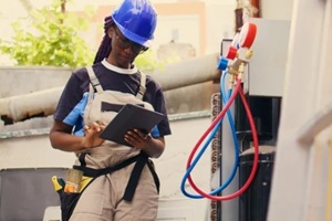 female plumber inspecting low pressure valves
