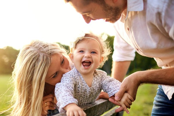 happy family standing by their home in maryland