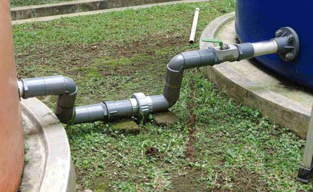 gray PVC pipe connection, including a green ball valve
