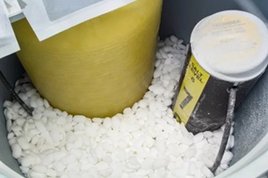 homeowner adds salt to a water softener