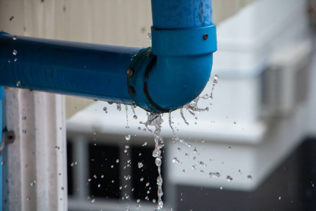 Closeup view of leaked and splash water from the plastic pipe