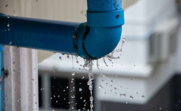 Closeup view of leaked and splash water from the plastic pipe