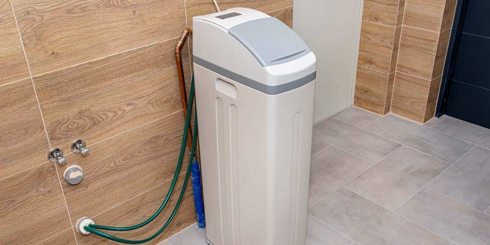 water softener standing in the boiler room with the lid closed