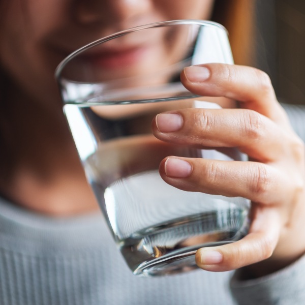 Closeup image of a beautiful young asian woman holding a glass