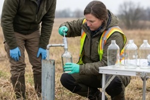 environmental scientists taking water samples from a groundwater well