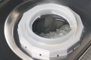 open compartment with salt for softening water in the dishwasher, close-up