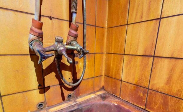 rust stains in bathtub on wall and bath. High level Iron dissolved In a water