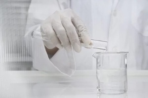 clean scientist in laboratory coat poring water from test tube into experimental beaker white science and technology banner background