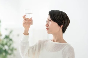 women looking at a glass of water